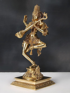 Brass Saraswati dancing statue with raised arms and drum, on ornate square pedestal.