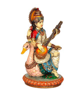 Resin Saraswati idol profile, veena and raised hand, seated on peacock base