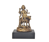 Gold-tone panchaloha deity idol on black base, centered front view