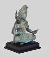 Vintage bronze Shiva statue, turquoise patina, side view seated with trident and layered jewelry