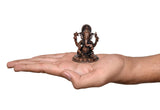 Copper Ganesha murti on open palm for scale, 2-inch height