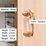 Brass door handle with golden finish and dolphin fish motif, fitted on wooden door