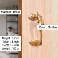 Brass door handle with golden finish and dolphin fish motif, fitted on wooden door