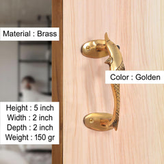 Brass door handle with golden finish and dolphin fish motif, fitted on wooden door