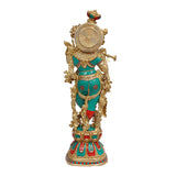 Back view of Krishna brass murti with teal outfit and gold detailing, red accents