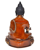 Rear view Buddha figurine, orange robe and dark textured hair on lotus base