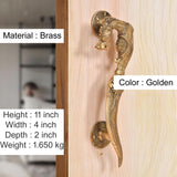 Golden brass yali-style door handles on plate, curved grip with engraved detailing