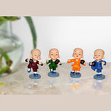 Resin kungfu monk figurines set in maroon, green, orange, blue, on round bases