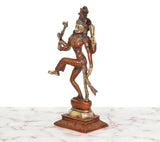Brass Ardhanarishvara dancing murti, side view with ornate base