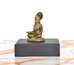 Golden Maa Annapurna Devi idol in profile, seated on black base (1.75 in)
