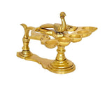 Brass peacock aarti diya with three visible bowl cups on each side and raised peacock finial