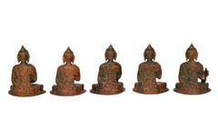 Back view of five brass Buddha statues, carved seated figures with textured details