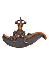 Brass dorje flaying knife top, dark curved blade with orange-gold grip, angled view