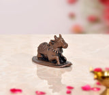 Copper Nandi cow idol on oval base, three-quarter view facing right