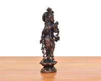 Copper Krishna playing flute murti, rear view with detailed ornaments and crown.