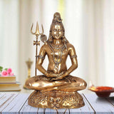 Brass Shiva penance pose, seated cross-legged with trident, detailed jewelry and headdress