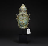 Antique bronze head idol of Lord Vishnu with serene face and ornate crown, on base