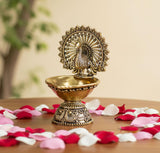 Brass peacock designer diya with fan crest and round oil cup, detailed base, 4-inch
