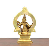 Brass Saraswati statue rear view, seated veena player behind halo arch