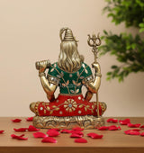 Lord Shiva brass murti side view, green and red garments, trident held upright