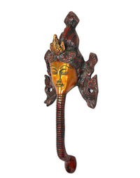 Angled brass Buddha face door pull with ornate side motifs