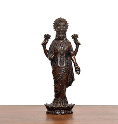 Lakshmi standing idol front view with crown, necklaces, and sculpted base pedestal