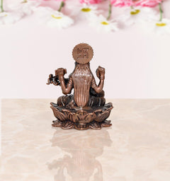 Back view of small Copper Maa Saraswati idol with crown and trident-like symbol