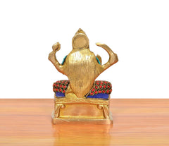 Back view of Santoshi Mata brass idol, multicolor jeweled shoulders and blue side panels