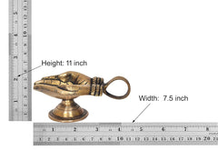 Brass hand-shaped diya with handle shown with measuring rulers for size