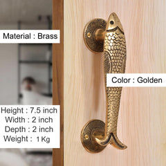 Golden brass fish-shaped door handles with textured scales and round rosettes.