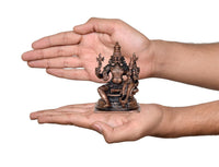 Copper 4-inch Lakshmi Narasimhar idol held in hands, compact pedestal base shown