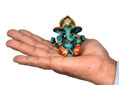 Ganesha resin idol statue in hand, 6 cm teal figure with red and gold detailing