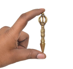 Brass Dorje Vajra Furba upright with three-pronged head, hand holding it