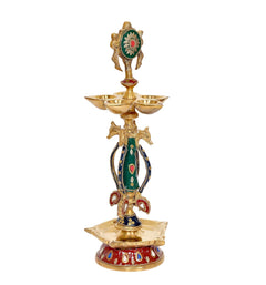 Brass chakra oil lamp diya with ornate green-red headpiece and three bowl top