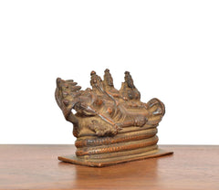 Copper Sheshashayi Vishnu idol with Lakshmi and Bhudevi, angled view
