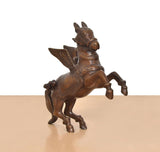 Brass flying horse with wings, profile view, wing spread and armored body details