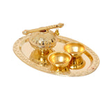 Decorated plate set with matki and two gold bowls on ornate round tray