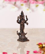 Copper Kartikeya Murugan idol, back three-quarter view, four arms holding symbolic items