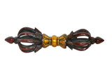 Front view of brass eight-pronged dorje with gold center and dark brown accents