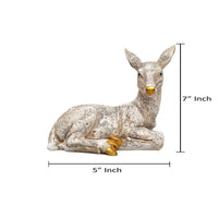Polyresin deer figurine: 5 in W x 7 in H, resting with gold accents