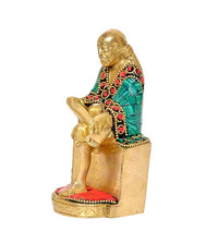Brass Sai Baba statue, side view with raised hand and red-detailed base
