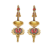 Front view: pair of brass bell diyas with central figures, two oil bowls and jeweled feet