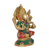 Three-quarter view brass Ganesha statue, curled trunk and green red painted garments