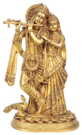Gold-tone brass Radha Krishna idol statue with peacock, detailed face and jewelry.