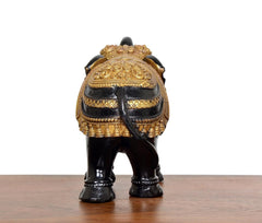 Black and gold elephant figurine, back view, gold head ornament and patterned armor
