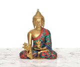 Seated Buddha statue with multicolor robe and gilded legs, front view