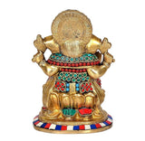 Brass Ganesha idol statue back view, circular halo design and jeweled waist ornaments