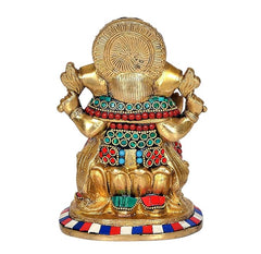 Brass Ganesha idol statue back view, circular halo design and jeweled waist ornaments