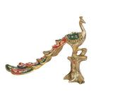 Brass peacock figurine with multicolor painted body and long tail on tree stump