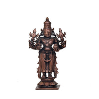 Copper Dhanvantari statue with ornate crown and four arms holding emblems